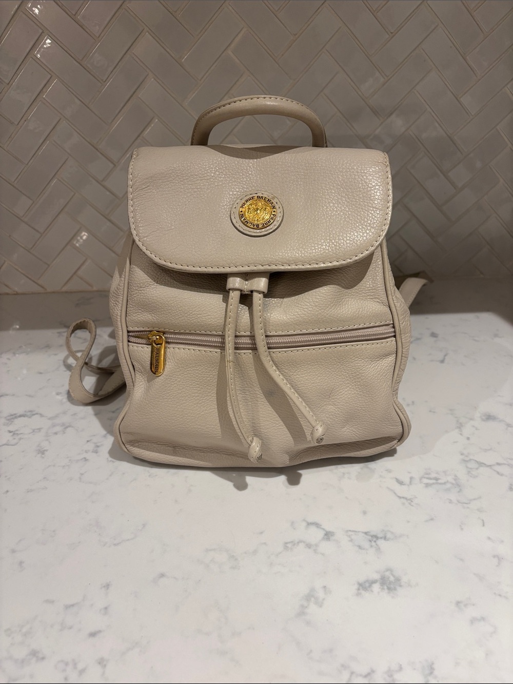 Pierre Balmain Beige Leather Drawstring Backpack with Gold Emblem